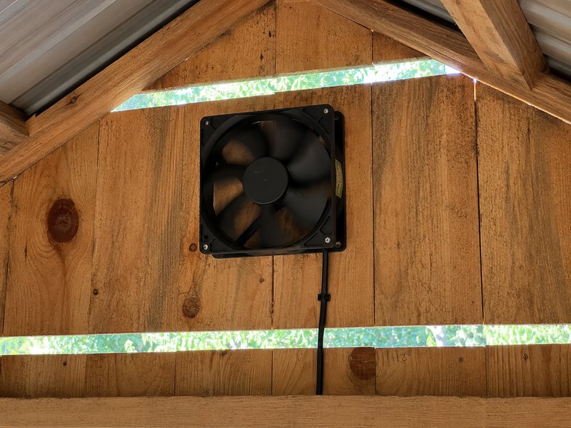 120mm brushless ventilation fan mounted at the roof peak inside a chicken coop